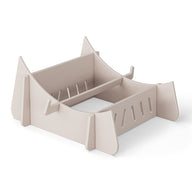 A beige cardboard laptop stand on a white background, the Signature Chaise Riser by Ledge Lounger, features a slotted design and raised support edges for securely holding your device, offering an elevated experience akin to a day by the pool.