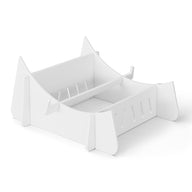 The Signature Chaise Riser by Ledge Lounger is a white minimalist book stand with two compartments, a curved base, and vertical slots. Its sleek modern design is perfect for organizing books upright against a plain white backdrop.