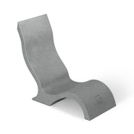 The Ledge Lounger Signature Chair With Short Riser is a modern gray lounge with smooth wave-like curves, crafted from solid material—ideal for stylish poolside seating and shown on a white background.
