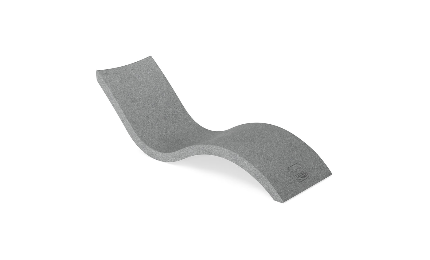 The Signature Chaise by Ledge Lounger is a sleek, modern gray lounger featuring an ergonomic wave design. Ideal for poolside relaxation, this chair is slightly elevated and designed to look like its crafted from one continuous piece.