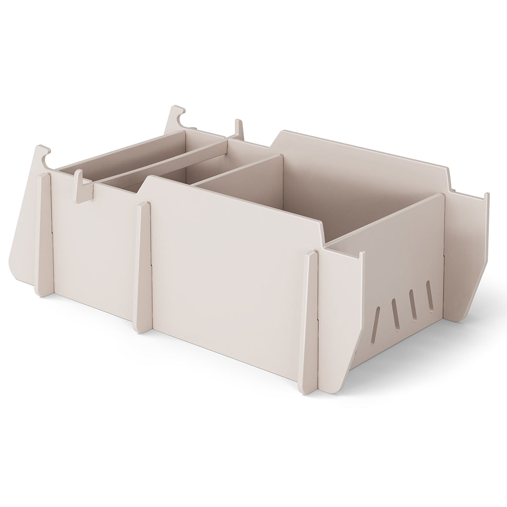 A beige, modular cardboard organizer with three compartments and interlocking panels on a white background features a stable design with a slightly raised edge, similar to the precision of products from Ledge Loungers Signature Lowback Chair Riser line.