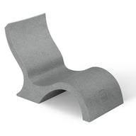 The Ledge Lounger Signature Lowback Chair With Short Riser offers modern poolside seating, featuring a sculpted gray design with a curved shape, elevated leg rest, and solid textured build—ideal for stylish outdoor relaxation.