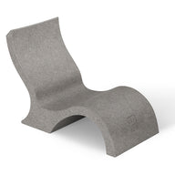 The Signature Lowback Chair With Short Riser by Ledge Lounger is a modern gray outdoor lounger with smooth curves and a minimalist, sculptural design, crafted from solid material and shown against a plain white background.