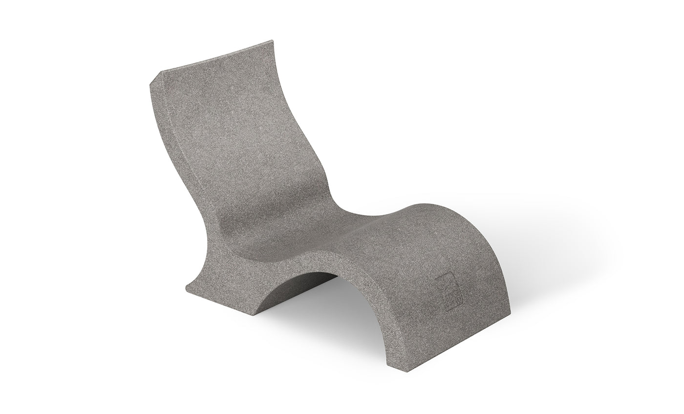 The Signature Lowback Chair With Short Riser by Ledge Lounger is a modern gray outdoor lounger with smooth curves and a minimalist, sculptural design, crafted from solid material and shown against a plain white background.