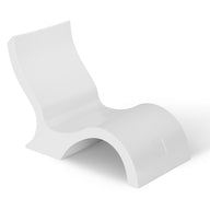 The Signature Lowback Chair With Riser by Ledge Lounger is a modern white outdoor lounger with smooth curves and a wave-like design, crafted from a single molded piece—ideal for relaxing poolside seating.