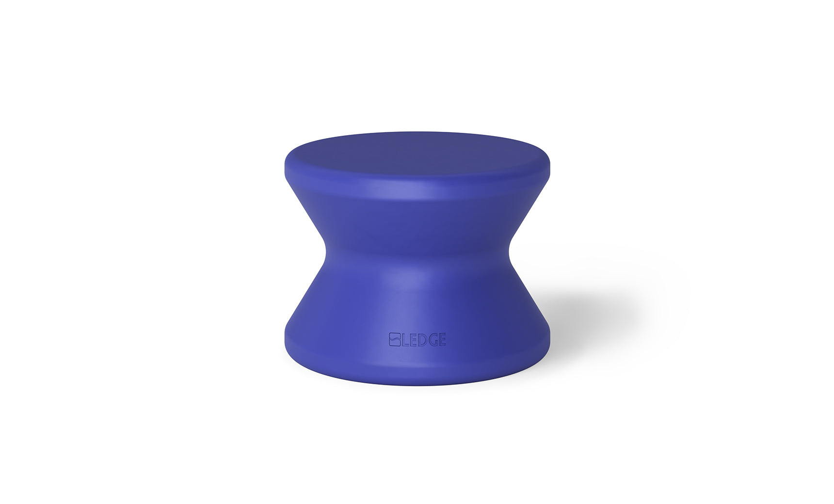 A compact, modern hourglass-shaped Signature Standard Side Table in blue, designed for pool use. The smooth surface discreetly displays the Ledge Lounger brand name on the side. Ideal for your sun shelf, it stands against a plain white background.