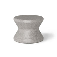 The Signature Standard Side Table by Ledge Lounger is a gray hourglass-shaped stool with a smooth surface, ideal for in-pool use. It complements any sun shelf setting and is set against a plain white background.