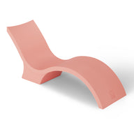 The Signature Chaise Deep by Ledge Lounger is a sleek, modern S-shaped lounge chair in pink. It features a smooth, curved seat and backrest with a sturdy base, ideal for relaxing on your tanning ledge while creating a subtle shadow on the white background.