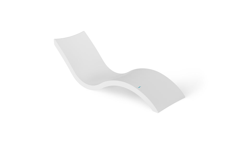 The Signature Chaise by Ledge Lounger is a sleek, modern white lounger featuring an ergonomic design with a smooth, curved silhouette against a plain white background, ideal for pool relaxation.