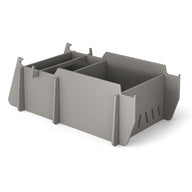 The Ledge Lounger Signature Lowback Chair With Tall Riser, a stylish grey seating option for outdoor spaces, is displayed on a plain white background.