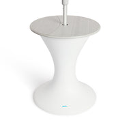 The Autograph Umbrella Stand Ice Bin by Ledge Lounger features a sleek design with a modern white pedestal base, a round gray top, and a central pole resembling an outdoor table. The flared base mimics an umbrella stand and showcases the small blue logo near the bottom.