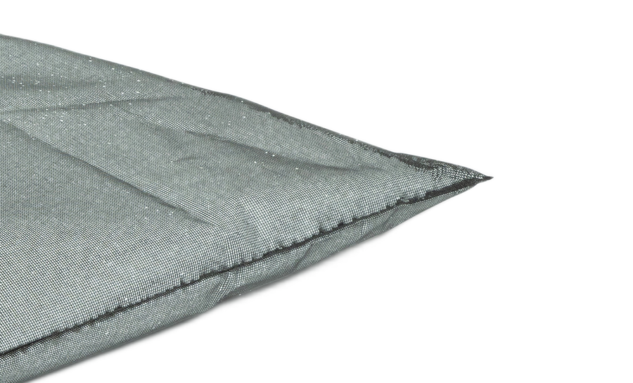 Close-up of the corner of a Laze Pillow Inner Bag by Ledge Lounger, showcasing its gray fabric, visible stitching, and textured surface, resting beside a Ledge Table Tennis Set with nearby ping pong paddles.