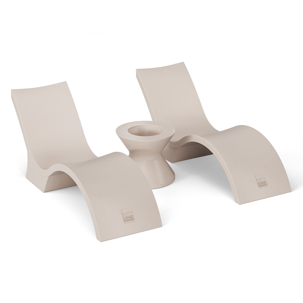 The Ledge Lounger Outdoor Oasis In-Pool Furniture Bundle features two modern beige Deep Chaise lounge chairs with curved designs, facing each other and separated by a matching ice bin side table, all set against a plain white backdrop to highlight their sleek, stylish look.