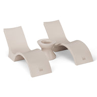The Ledge Lounger Outdoor Oasis In-Pool Furniture Bundle features two modern beige Deep Chaise lounge chairs with curved designs, facing each other and separated by a matching ice bin side table, all set against a plain white backdrop to highlight their sleek, stylish look.