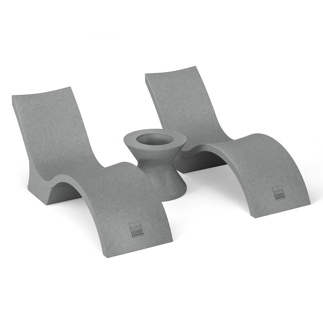 Two sleek, sculptural gray lounge chairs with curved bases from the Ledge Lounger Outdoor Oasis In-Pool Furniture Bundle - Deep Chaise flank a matching ice bin side table. The minimalist set, with a smooth finish, is positioned symmetrically against a plain white backdrop.