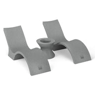 Two sleek, sculptural gray lounge chairs with curved bases from the Ledge Lounger Outdoor Oasis In-Pool Furniture Bundle - Deep Chaise flank a matching ice bin side table. The minimalist set, with a smooth finish, is positioned symmetrically against a plain white backdrop.
