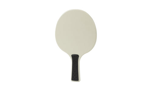 The Ledge Lounger Table Tennis Paddle features a simple oval beige face and a short black textured handle, displayed against a plain white background.