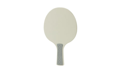 A beige Table Tennis Paddle by Ledge Lounger with an oval shape, light gray gripped handle, and dotted texture is displayed on a white background—perfect for any Ledge Table Tennis Set.
