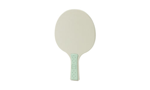 A simple beige Table Tennis Paddle with a light green handle from Ledge Lounger, shown against a white background.