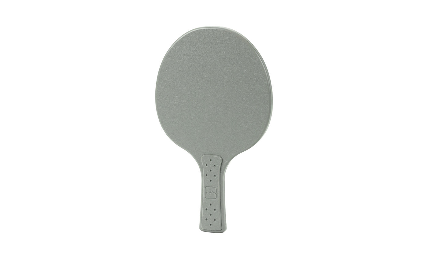 A gray Table Tennis Paddle by Ledge Lounger, featuring a textured handle and smooth surface, displayed on a white background. Ideal addition to your Ledge Table Tennis Set.