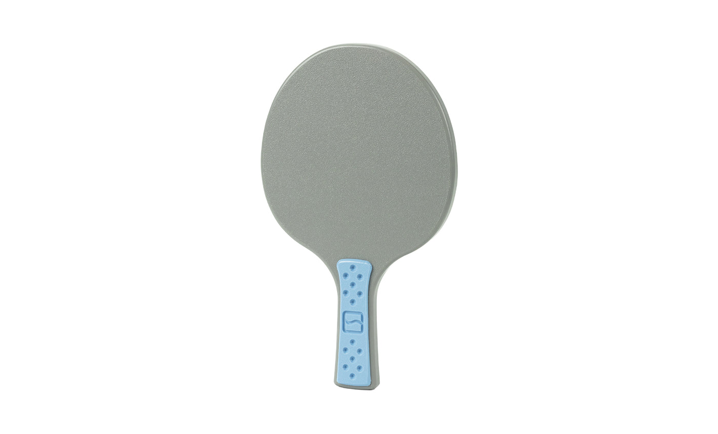 A gray Table Tennis Paddle by Ledge Lounger, with a light blue handle detailed with small dark blue dots, is displayed against a white background.