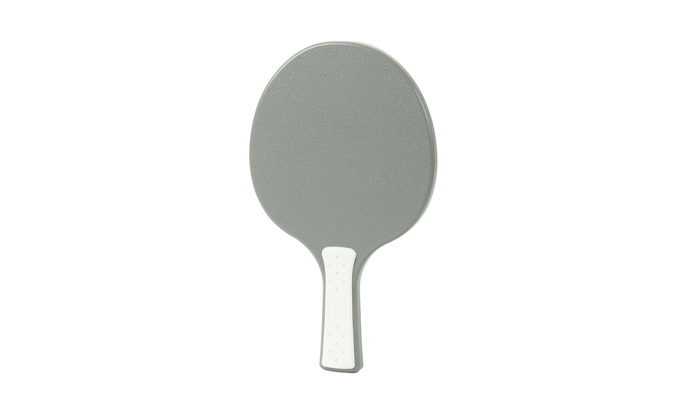 A gray Table Tennis Paddle by Ledge Lounger, featuring a white handle, is displayed on a plain white background.