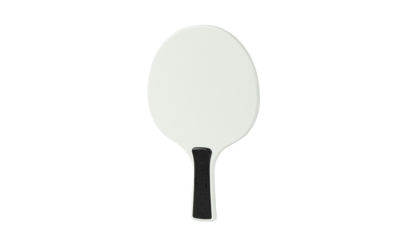 An oval-shaped white Table Tennis Paddle with a black handle from Ledge Lounger, displayed on a plain white background.
