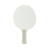 The Table Tennis Paddle by Ledge Lounger features a white plastic surface and a beige textured handle, resembling a traditional table tennis paddle, shown against a plain white background.