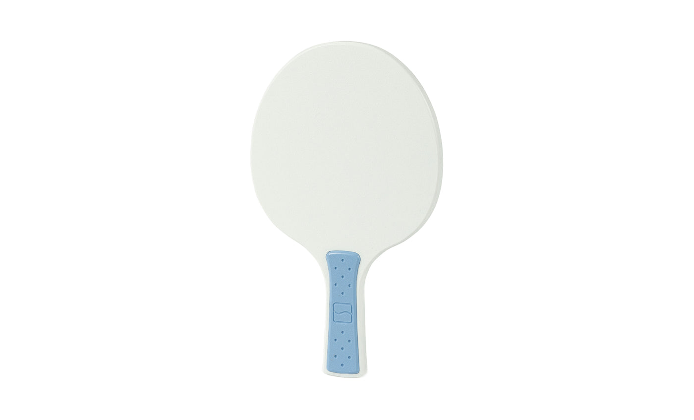 The Ledge Lounger Table Tennis Paddle features an oval-shaped white head and a light blue handle, displayed on a plain white background—an ideal addition to any table tennis set.