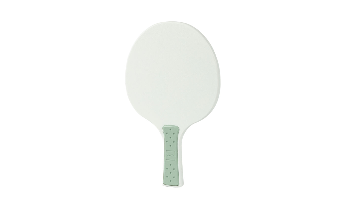 The Ledge Lounger Table Tennis Paddle features a white, oval-shaped face and a light green textured handle, shown isolated on a white background.