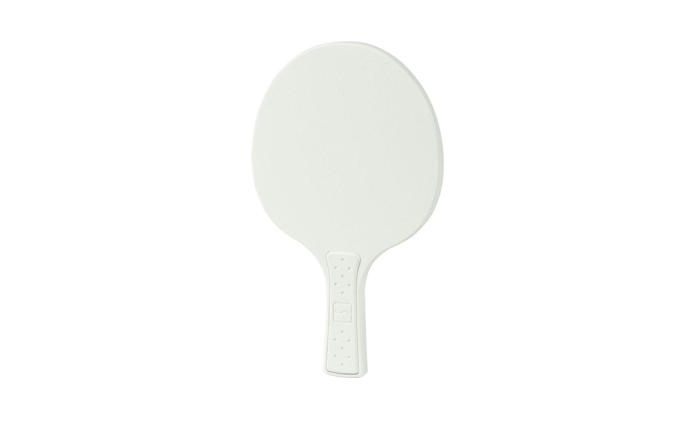 The Ledge Lounger Table Tennis Paddle features an oval shape with a textured surface and short handle, reminiscent of a ping pong paddle, displayed against a plain white background.