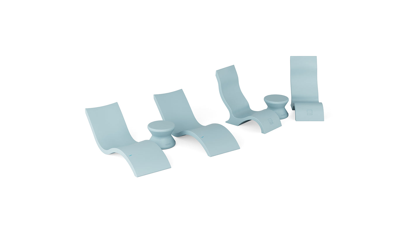 The Ledge Lounger Signature Chaise with Chairs and Side Table In-Pool 6-Piece Set features four modern light blue loungers and matching round side tables, ideal resort-style pool furniture for a chic, relaxing poolside vibe.