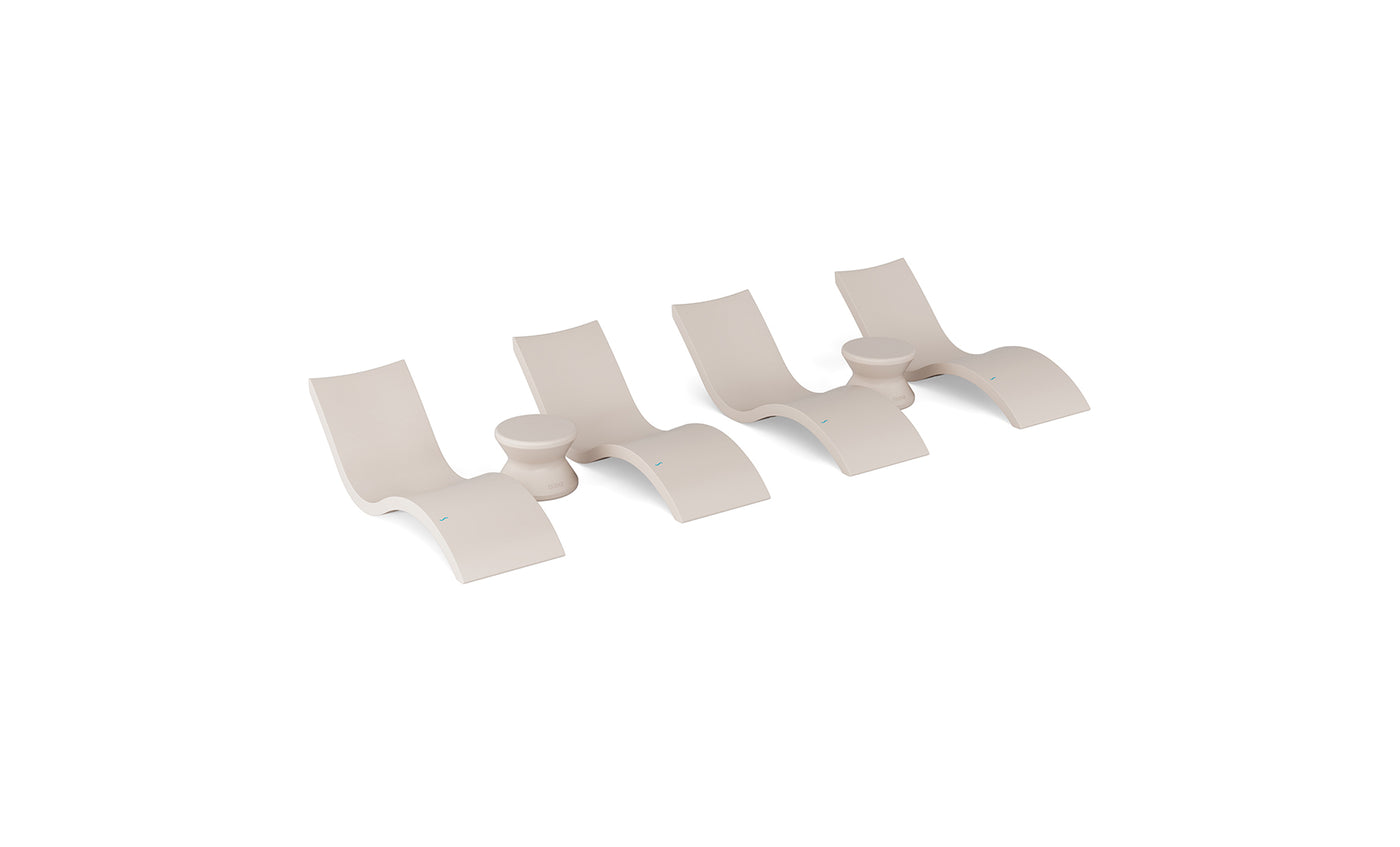 The Ledge Lounger Signature Chaise and Side Table In-Pool 6-Piece Set features modern beige wave-shaped chaise loungers with built-in cup holders, arranged in a row as stylish pool ledge furniture on a white background.