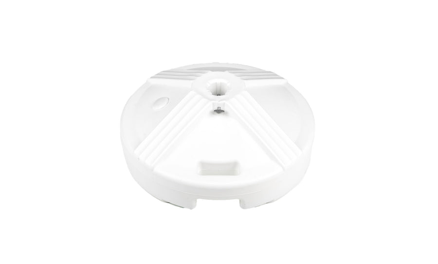 A white, circular object with radial ridges and a central hole is set against a plain background, resembling tranquility akin to an outdoor dining space. This is the Resin Coated Concrete Umbrella Base by Ledge Lounger.