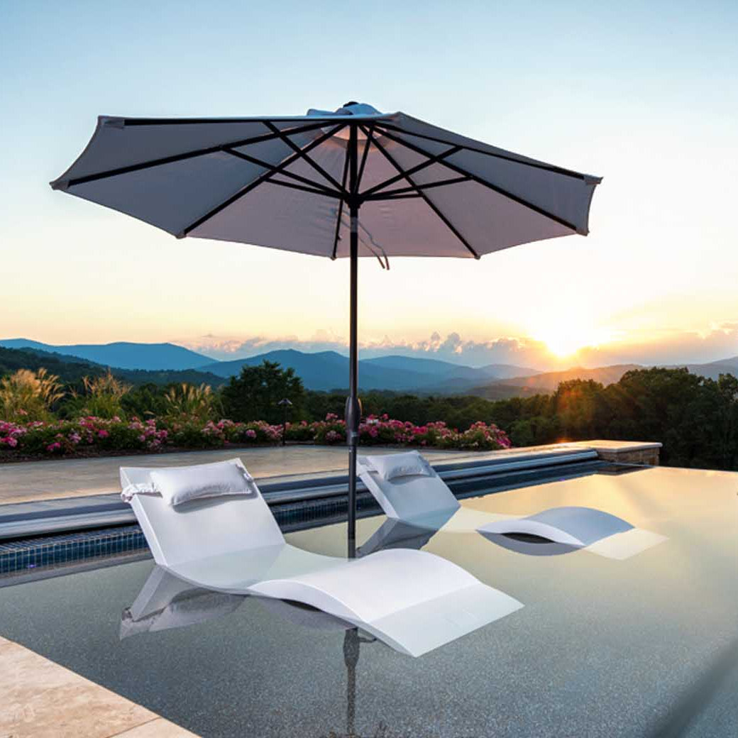 Ledge Lounger in-pool umbrella and chaises.