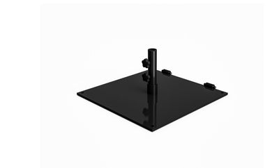 The Ledge Lounger Steel Plate Umbrella Base includes a black metal base with a powder-coated finish, a central cylindrical pipe, adjustable knobs, and corner holes for secure mounting. Perfect for supporting center pole umbrellas.