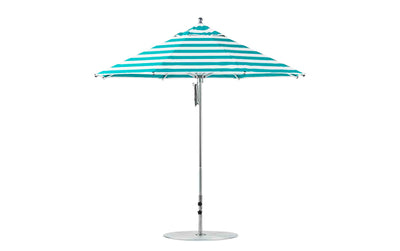 The Ledge Lounger Premier 9 Octagon Pulley Aluminum Umbrella features teal and white stripes, stands tall on a metal pole with a round base, and is made of marine-grade fabrics for durability.