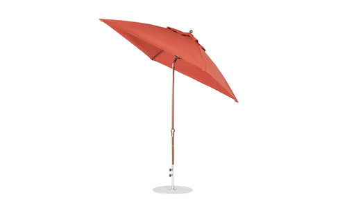 The Ledge Lounger Essential Fiberglass Umbrella, 7.5 in red with a wooden pole and metal base, offers a modern minimalist design. Partially open and tilted, its crafted with marine-grade fabrics for wind resistance in any outdoor setting.