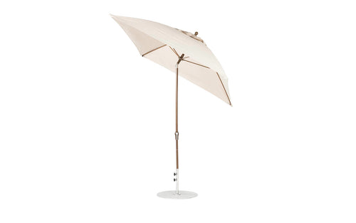 The Ledge Lounger Essential Fiberglass Umbrella - 7.5 Octagon Crank Auto Tilt features a beige marine-grade fabric canopy with a wooden pole and metal base. Wind-resistant and stylish, its perfect for outdoor spaces, shown tilted against a white background.