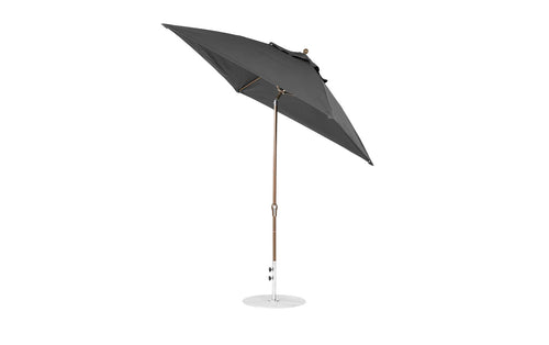The Essential Fiberglass Umbrella - 7.5 Octagon Crank Auto Tilt by Ledge Lounger, made from marine-grade fabrics, features a wooden pole and metal base. The wind-resistant black umbrella tilts slightly to the side against a plain white background, showcasing its design and structure.