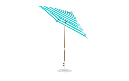 The Ledge Lounger Essential Fiberglass Umbrella - 7.5 Octagon Crank Auto Tilt, featuring wind-resistant marine-grade turquoise and white striped fabric and a wooden pole, stands upright against a plain white background on a sturdy circular base.
