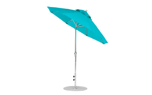 The turquoise Essential Fiberglass Umbrella by Ledge Lounger, featuring a metal pole and circular base, elegantly showcases its open canopy and ribs. Made with marine-grade fabrics, it includes a tilt and height adjustment mechanism against a plain white background.