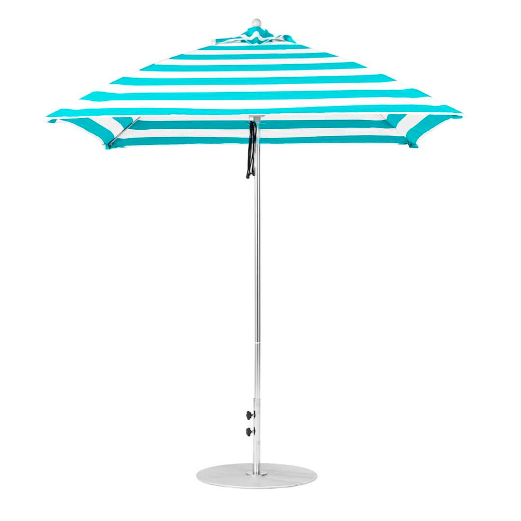 The Ledge Lounger Essential Fiberglass Umbrella - 7.5 Square Pulley, made from marine-grade fabrics with turquoise and white stripes, stands open on a slender silver pole with a round base, ideal for outdoor use at the beach or in a garden.