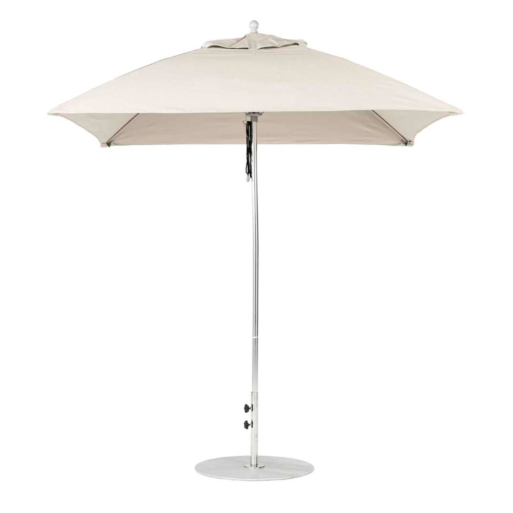The beige Essential Fiberglass Umbrella by Ledge Lounger boasts a classic design with a 7.5 square canopy made of marine-grade fabric. It features a sleek metal pole and circular base, providing perfect outdoor shade and ensuring compatibility through the Umbrella Compatibility Matrix for versatile use.