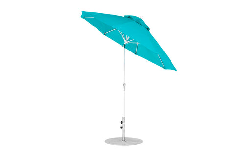 The Essential Fiberglass Umbrella by Ledge Lounger, a 7.5 Octagon Crank Auto Tilt model, showcases a teal canopy and silver pole anchored to a circular silver base with marine-grade fabric.