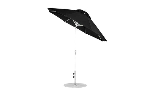 A Ledge Lounger Essential Fiberglass Umbrella, featuring a silver pole and marine-grade fabrics, stands open on a round silver base. This wind-resistant, sleek umbrella is slightly tilted, with adjustable knobs for convenience.