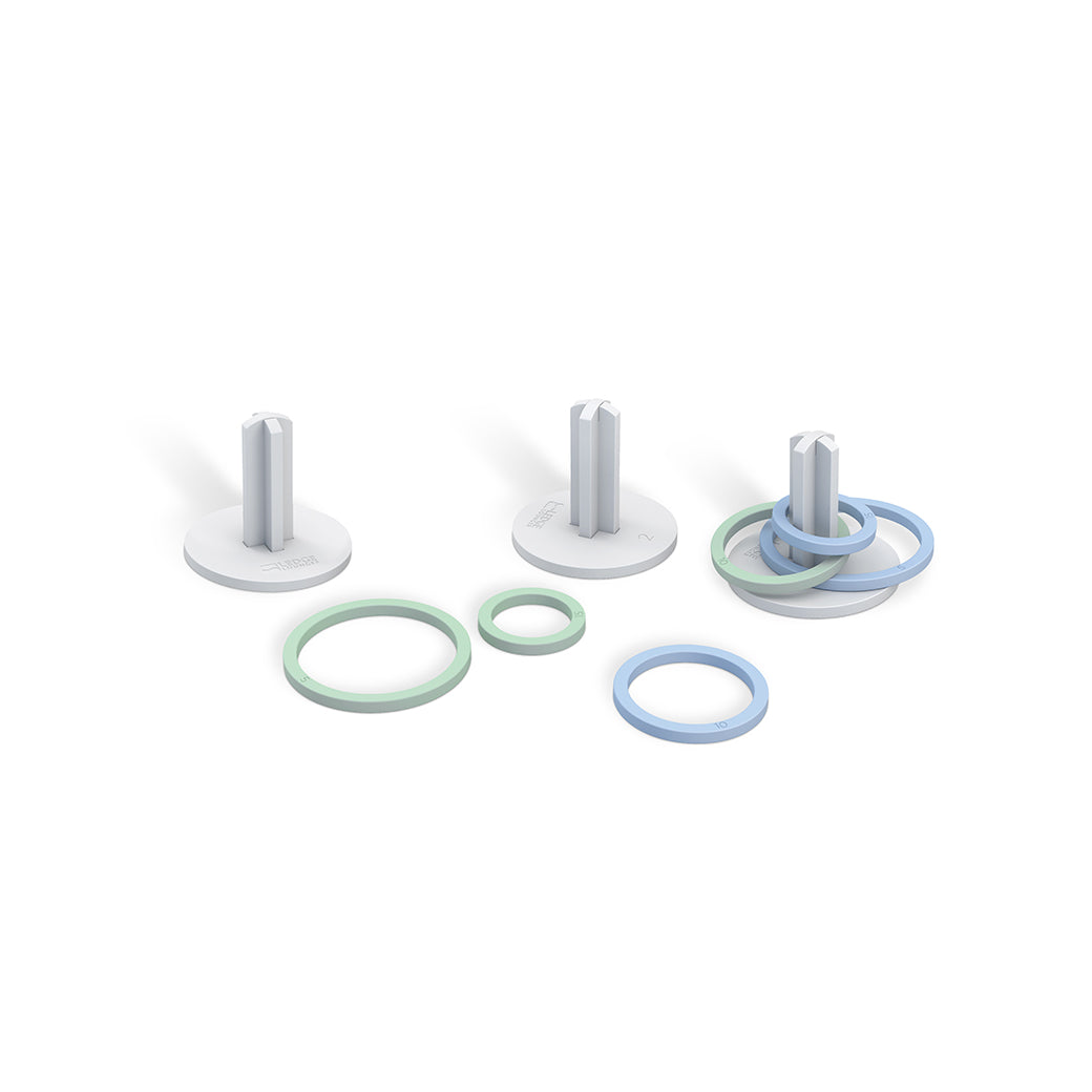 Three Ledge Lounger white cylindrical pegs on circular bases, surrounded by pastel blue and green rings, resemble a Ring Toss setup. Set against a plain white background, it invites a playful outdoor game experience.