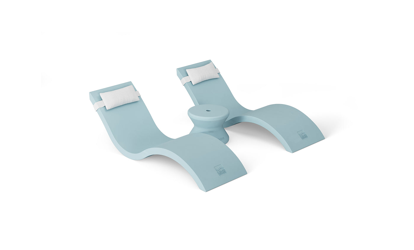 Introducing the Outdoor Paradise In-Pool Furniture Bundle by Ledge Lounger—featuring a modern, light blue chaise with two reclining sections, built-in headrests, and a wave-like design. Perfect for water use, it includes a central space for an umbrella or accessory, ideal for your outdoor oasis.