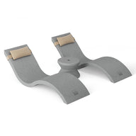 The ergonomic gray laptop stand, crafted from smooth material with a curved design and beige padded ends, offers central elevation for support. Ideal for using poolside, it complements the Ledge Lounger Outdoor Paradise In-Pool Furniture Bundle when placed against a plain white background.