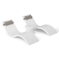 The Outdoor Paradise In-Pool Furniture Bundle by Ledge Lounger features a sleek, modern white lounge chair with gray cushion headrests. With its wave-like design, its perfect as pool ledge furniture or an in-pool chaise lounger, showcasing minimalist elegance against a white backdrop.
